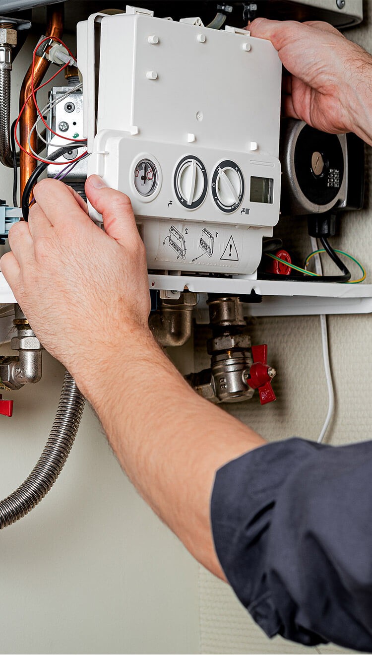 Gas Safe registered enfineer repairing a boiler in a London property