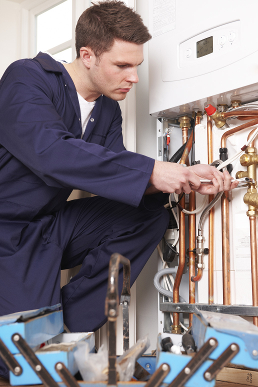 Expert gas boiler service in London Gas boiler service engineer while working