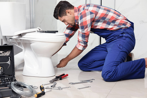 Reliable toilet leak repair in London Plumber repairing a leaking toilet