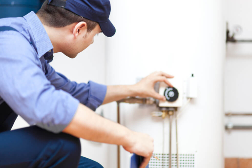 Get reliable unvented hot water cylinder installation in London Plumber installing unvented hot water cylinder in a London property