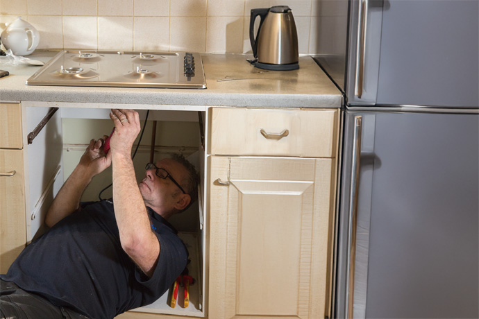 Get expert gas hob repair for your London home Engineer repairing a gas hob in London home